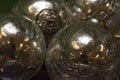 Bright, shiny, silver-colored metallic balls are viewed close-up and grouped together Royalty Free Stock Photo