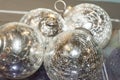 Bright, shiny, silvery metallic balls or Christmas decorations are viewed in close-up. Royalty Free Stock Photo