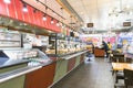 Bright shot of burgers, donuts and sandwiches in a bakery or shop glass counter.