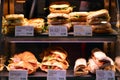 Bright shot of burgers, donuts and sandwiches in a Starbucks Coffee. Shiny showcase of baked fastfood with prices.