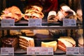 Bright shot of burgers, donuts and sandwiches in a Starbucks Coffee. Shiny showcase of baked fastfood with prices.