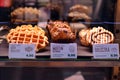 Bright shot of burgers, donuts and sandwiches in a Starbucks Coffee. Shiny showcase of baked fastfood with prices.