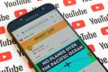 Bright Side official youtube channel on smartphone screen on paper youtube background