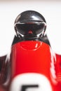 Bright silver helmet on a racing driver on a red toy vintage racing car Royalty Free Stock Photo