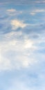 Bright sky with white and blue clouds, vertical format Royalty Free Stock Photo