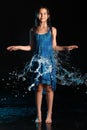 Dark-haired brown-eyed teenage girl posing in a black aqua-zone. Royalty Free Stock Photo