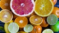 Bright slices of tangerines lemons oranges limes citrus fruits close up on a wooden background Royalty Free Stock Photo