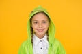 Bright smile whatever the weather. Little girl with cute smile in hood on yellow background. Smiling kid with white Royalty Free Stock Photo