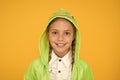 Bright smile whatever the weather. Little girl with cute smile in hood on yellow background. Smiling kid with white Royalty Free Stock Photo