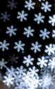 Bright snowflakes vertical bokeh background.