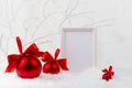 Bright soft christmas background with blank poster mockup for presentation, display with festive red balls with red satin ribbons. Royalty Free Stock Photo