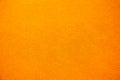 Bright solid color background. Empty orange surface with fine texture. Preparation for designer or layout