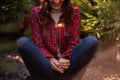 Bright sparkler burns in womans hands. Girl in red checkered shirt smiles. Atmosphere of Christmas Royalty Free Stock Photo