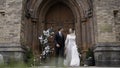 A bright and spectacular wedding couple. Action.Newlyweds where a bride in a white dress with a slit on her leg and a Royalty Free Stock Photo