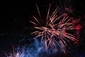 Bright splashes of festive fireworks, golden in color, with blue and red haze, against the background of the night sky Royalty Free Stock Photo