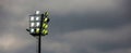 Bright sports stadium lights on a cloudy evening Royalty Free Stock Photo