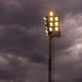 Bright sports stadium lights on a cloudy evening Royalty Free Stock Photo