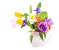 Bright spring bouquet in a white vase. spring flowers, daffodils, tulips, hyacinths, irises and mimosa isolated on a Royalty Free Stock Photo