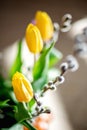 Bright spring bouquet of yellow and purple tulips and branches pussy willows. Easter arrangement of fresh flowers