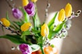 Bright spring bouquet of yellow and purple tulips and branches pussy willows. Easter arrangement of fresh flowers