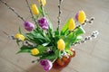 Bright spring bouquet of yellow and purple tulips and branches pussy willows. Easter arrangement of fresh flowers