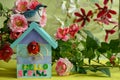 bright spring decoration with birdhouse,birds and artificial flowers.