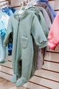 Bright spring jumpsuits for newborns hang on hangers in a children's clothing store Royalty Free Stock Photo