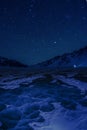 Bright stars above a winter lake Baikal. Royalty Free Stock Photo