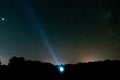 Bright stars and constellations in the night sky. The silhouette of a man against the background of the starry sky. A man shines a Royalty Free Stock Photo