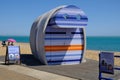 Bright strippy modern beach hut for hire at Eastbourne beach. Taken on a bright blue sky summer`s afternoon