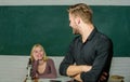 Bright student. High school student saying lesson. Male student with examiner at examination. Handsome man standing Royalty Free Stock Photo