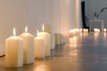 bright studio with a line of unlit candles