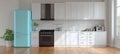 Bright and Stylish Contemporary Kitchen Interior Featuring Blue Refrigerator and White Cabinets Royalty Free Stock Photo