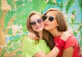 Bright stylish lifestyle urban portrait of two pretty best friends girls in sunglasses. Having fun, kiss and say hello. Two funny Royalty Free Stock Photo