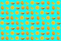 Bright summer background. Orange slices on blue. Fruits seamless pattern. Oranges texture design for textiles, wallpaper, fabric