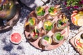 Bright summer cocktails with fruits grapefruit, lime, lemon and mint in glass glasses stand on a round wooden tray on the stones Royalty Free Stock Photo