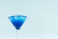 Bright summer fresh blue fruit cocktail with blue curacao liquor, ice cubes in pastel mint color background, top part, details. Royalty Free Stock Photo