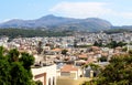Bright summer photo panorama of the city of Rethymno, Crete island, Greece. On the image of the roofs of houses, trees