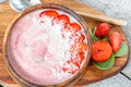 Bright summer strawberry-banana smoothie bowl with coconut. Royalty Free Stock Photo