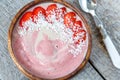 Bright summer strawberry-banana smoothie bowl with coconut. Royalty Free Stock Photo