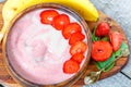 Bright summer strawberry-banana smoothie bowl. Royalty Free Stock Photo