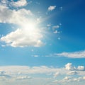 Bright sun on beautiful blue sky with white clouds Royalty Free Stock Photo