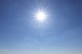 Bright sun in blue sky. Halo effect Royalty Free Stock Photo