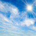 The bright sun, blue sky and light clouds Royalty Free Stock Photo