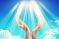 Bright sun light between two hands over blue sky Royalty Free Stock Photo