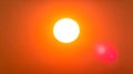Bright Sun Radiating Warm Light Through an Orange Sky Royalty Free Stock Photo