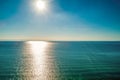 Bright sun rays over calm sea water.