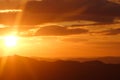 Bright orange sunset over the mountains in Montenegro.