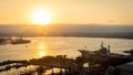 Bright sun sets over the USS Midway on San Diego Bay in Southern California