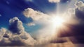 The bright sun shines from behind the clouds in the blue sky. Bright sun rays shine on the clouds. International Sun Day Royalty Free Stock Photo